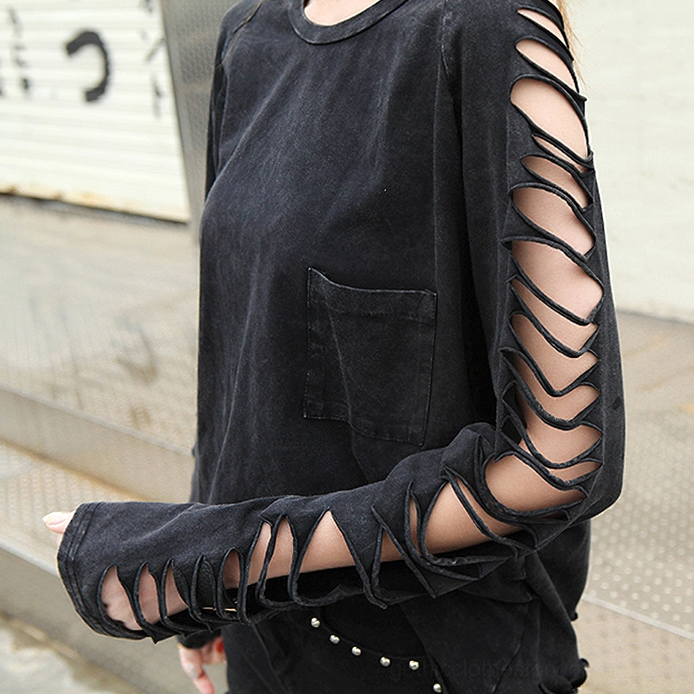 Close-up side profile of model wearing black gothic cutout long sleeve tee with chest pocket detail and studded accessories