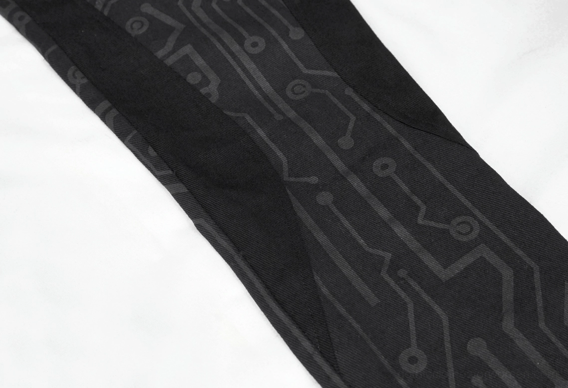 Black side panel contrast fabric detail on circuit printed gothic cyberpunk pants
