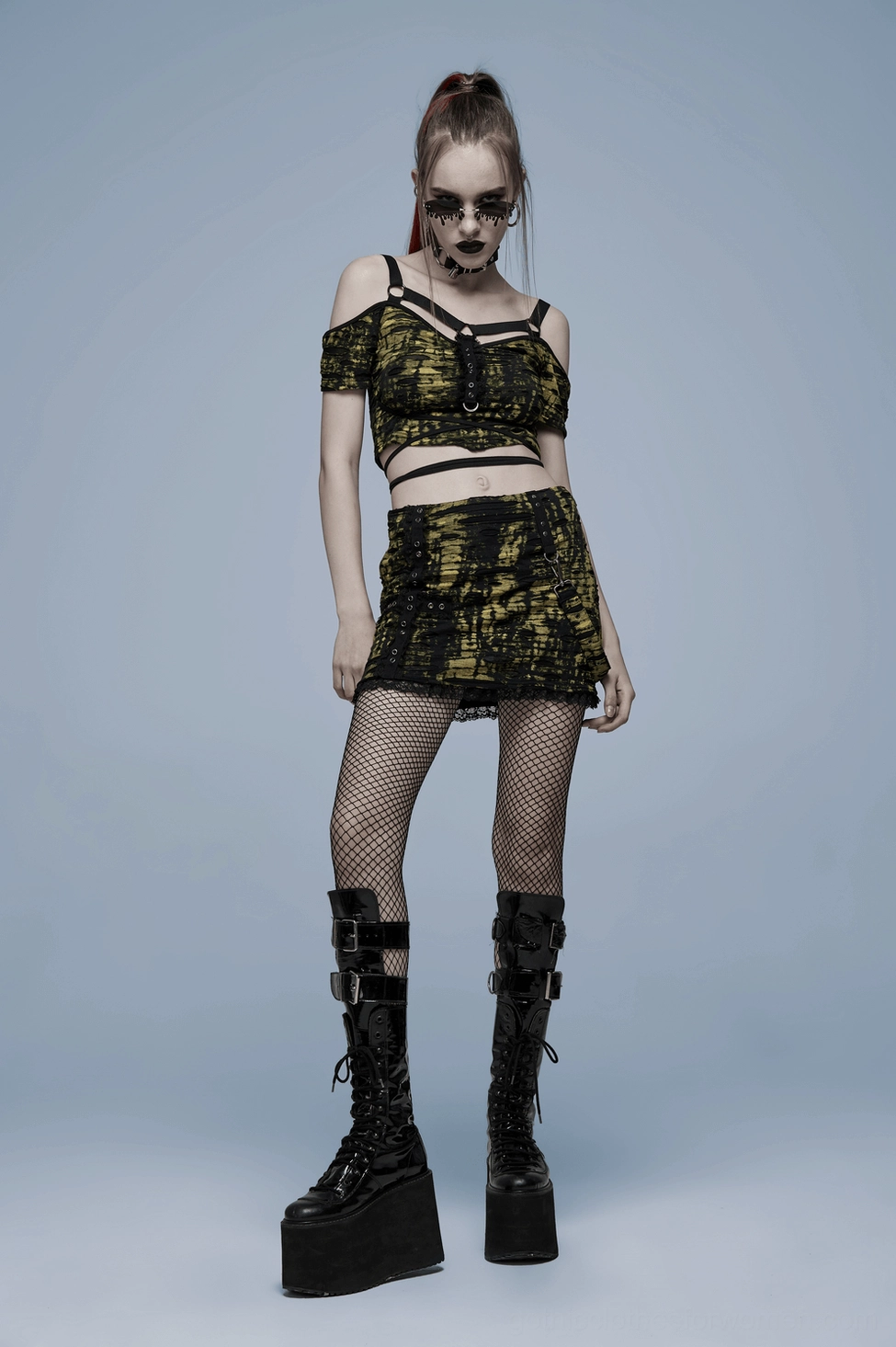 Professional product shot of black and yellow gothic distressed knit mini skirt highlighting deconstructed design elements