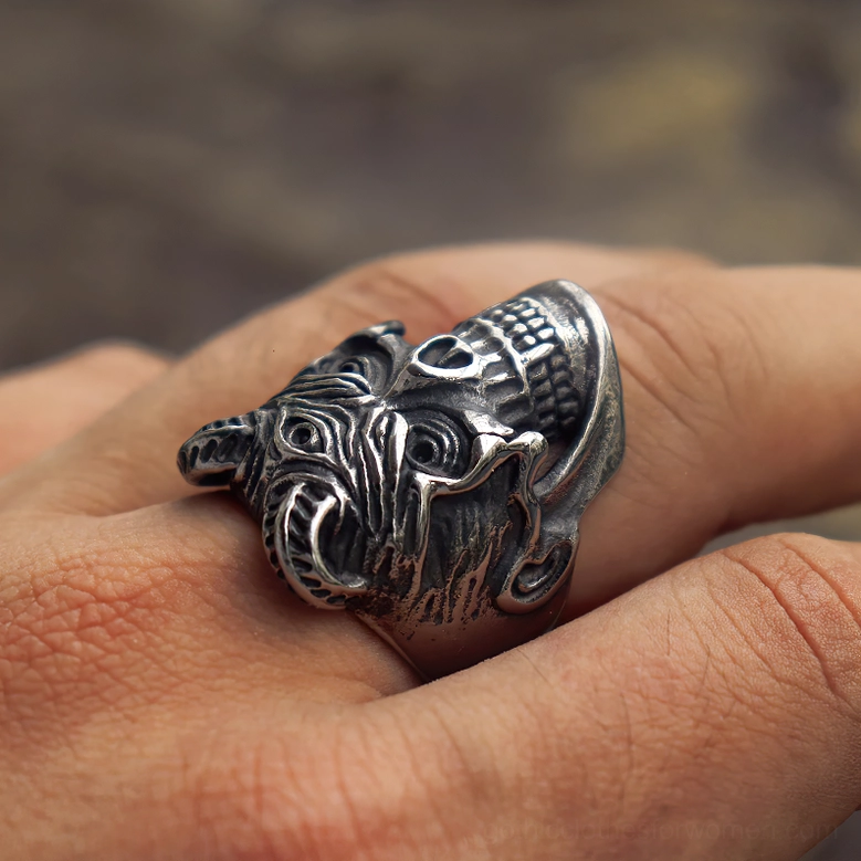 Side rear view of demon skull ring on hand displaying horned design and textured metal surface