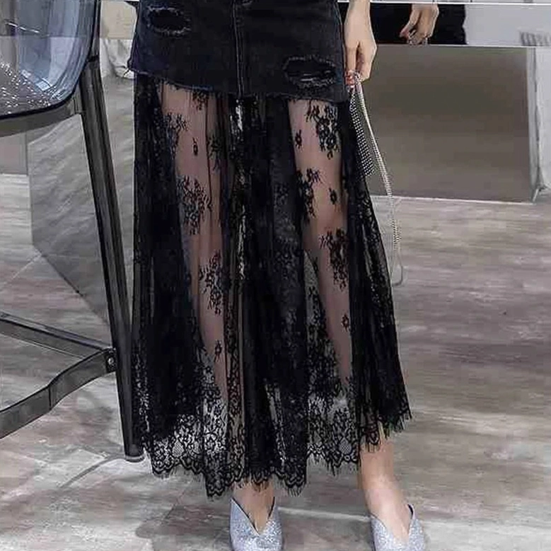 Black distressed denim gothic midi skirt lower hem detail - front partial view showing sheer lace and transparent mesh overlay
