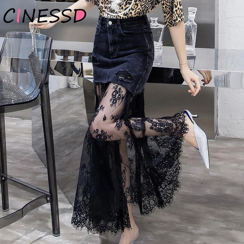 Black distressed denim gothic midi skirt styled in modern interior - side view showing sheer lace hem and silhouette with pointed heels