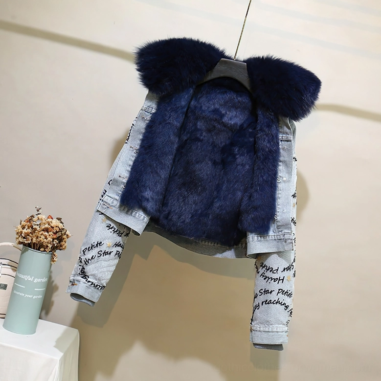 Studio display of dark navy gothic denim parka with navy inner fur and letter print sleeve details