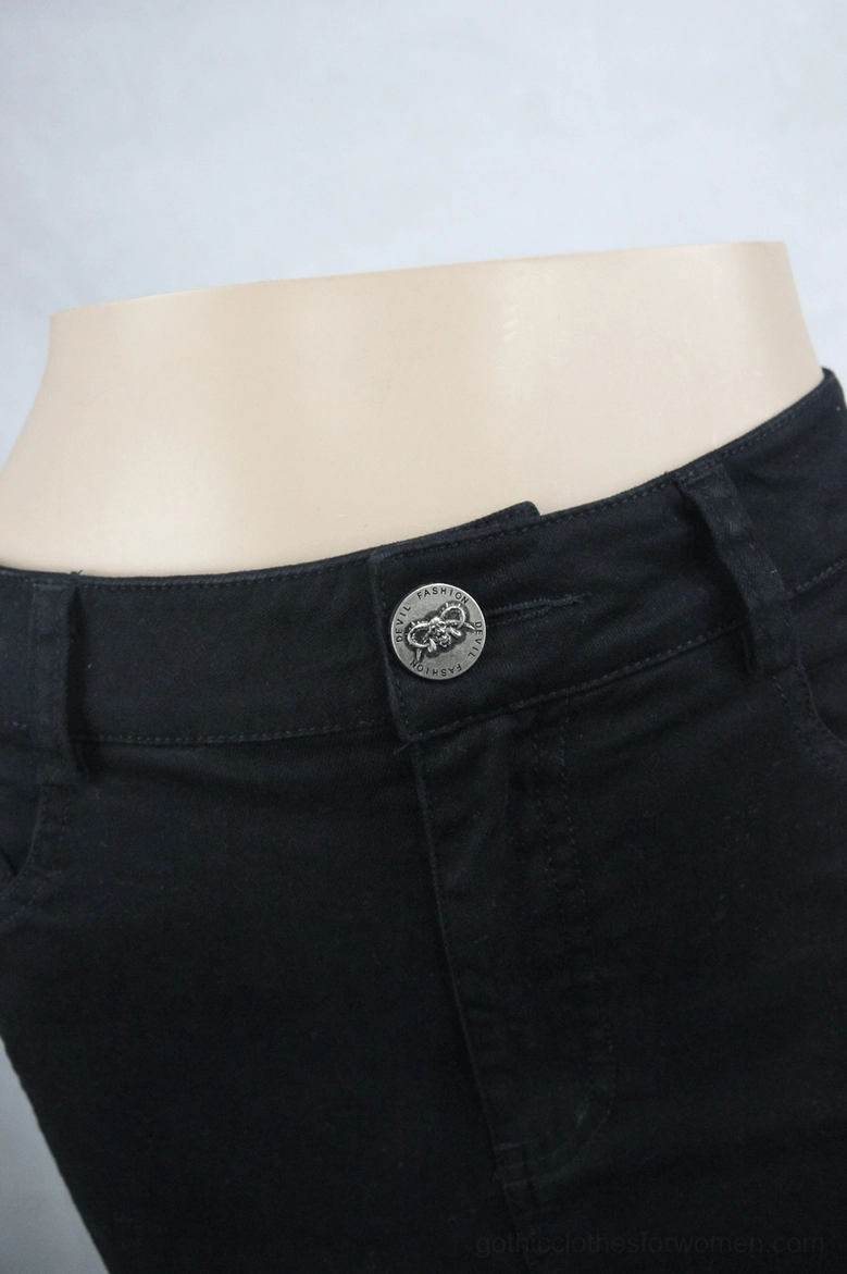 Close-up of gothic denim skirt waistband - silver skull-button metal closure and belt loops