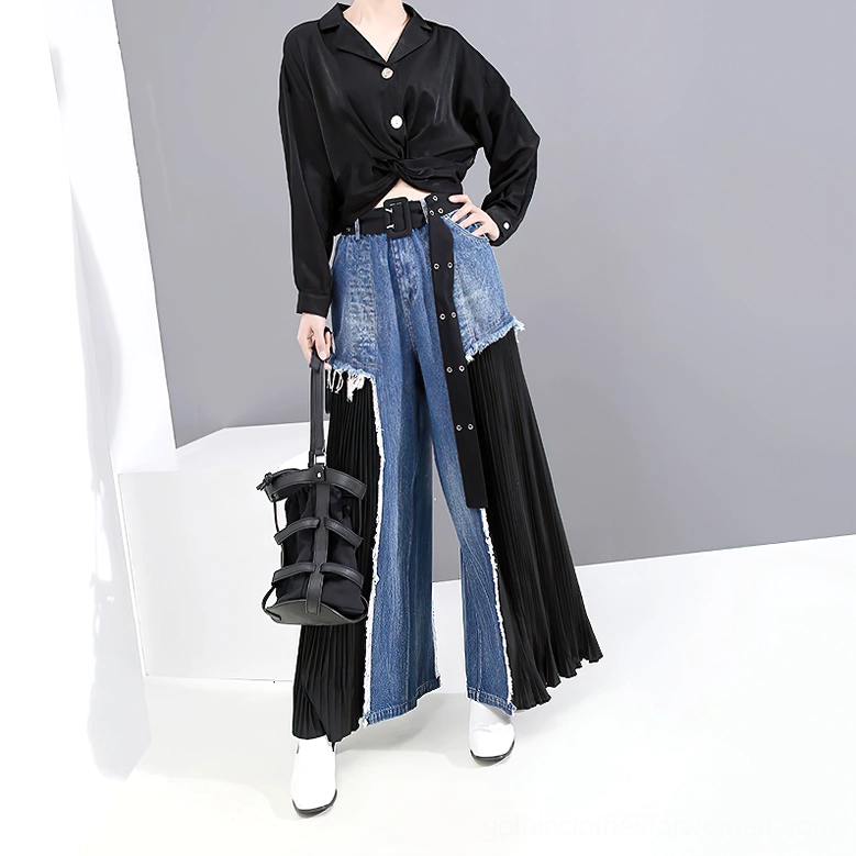 Model wearing patchwork gothic denim wide-leg trousers styled with black cropped shirt and structured handbag, front angle outfit inspiration