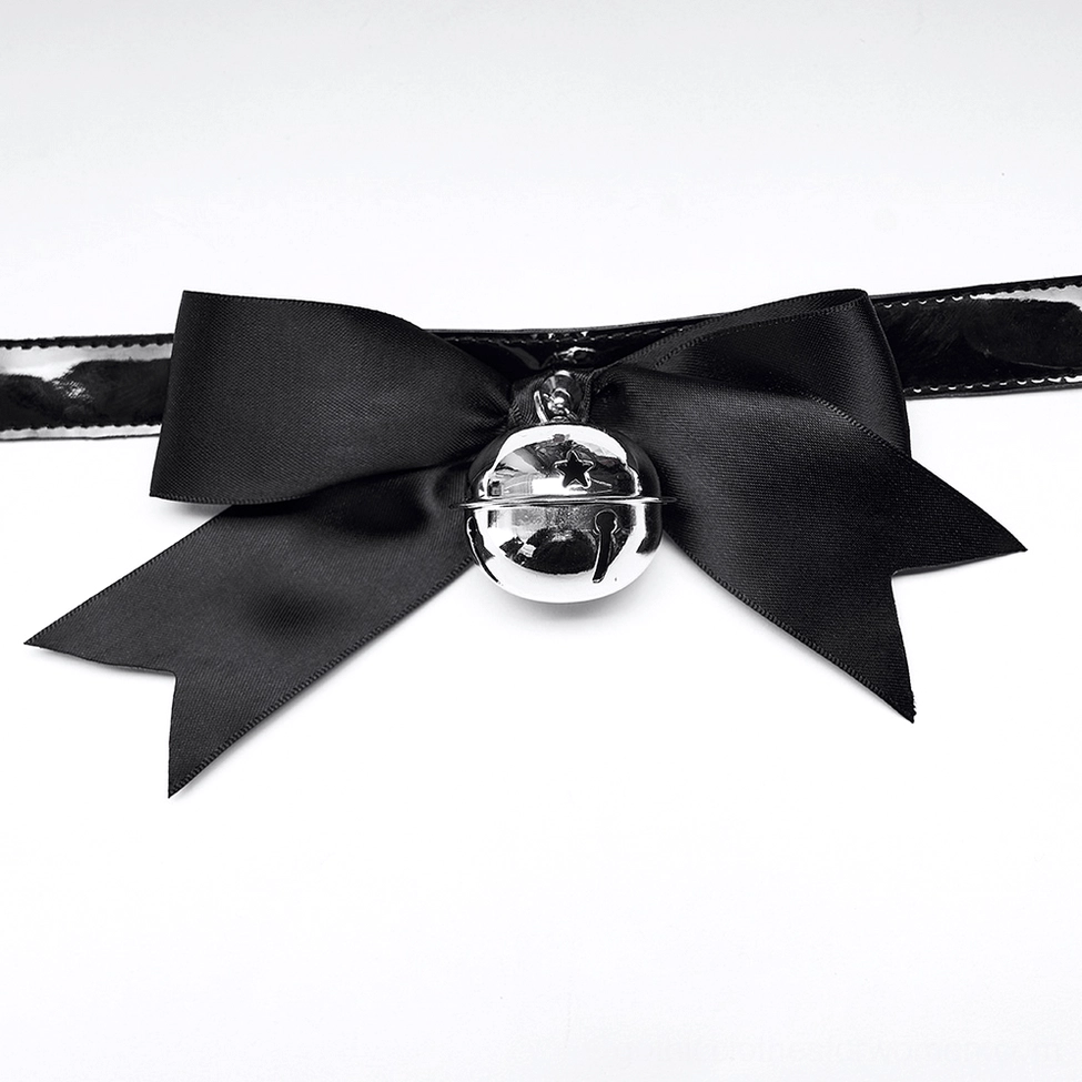 Close-up of detachable black satin bow with silver metal bell accent, gothic choker accessory