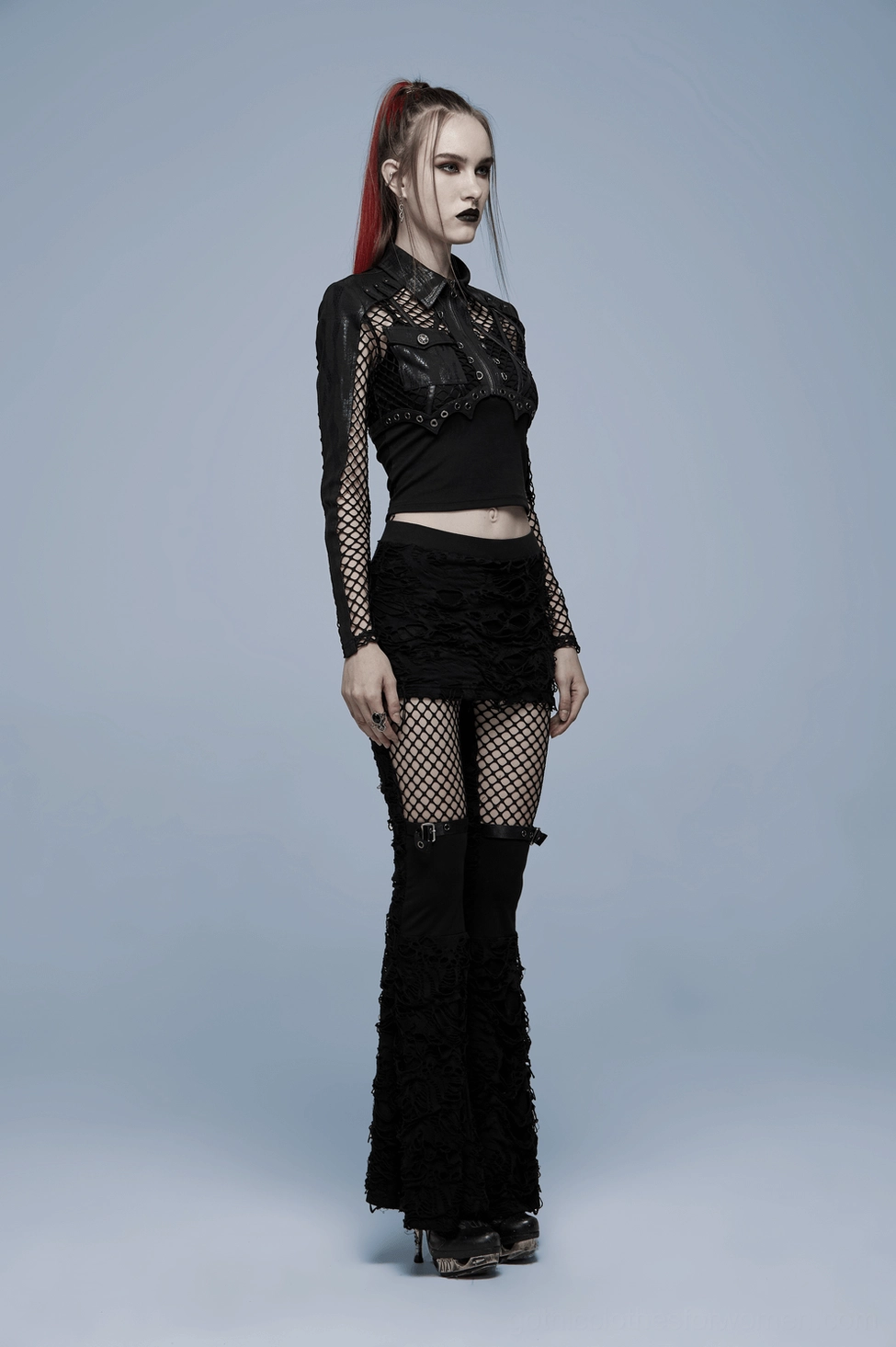 Black gothic distressed flare pants with fishnet inserts and bell bottom design, complete outfit view