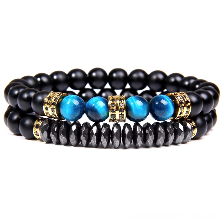 Alternative gothic beaded bracelet with matte black round flat stone beads, blue tiger eye, and gold tone metal spacers