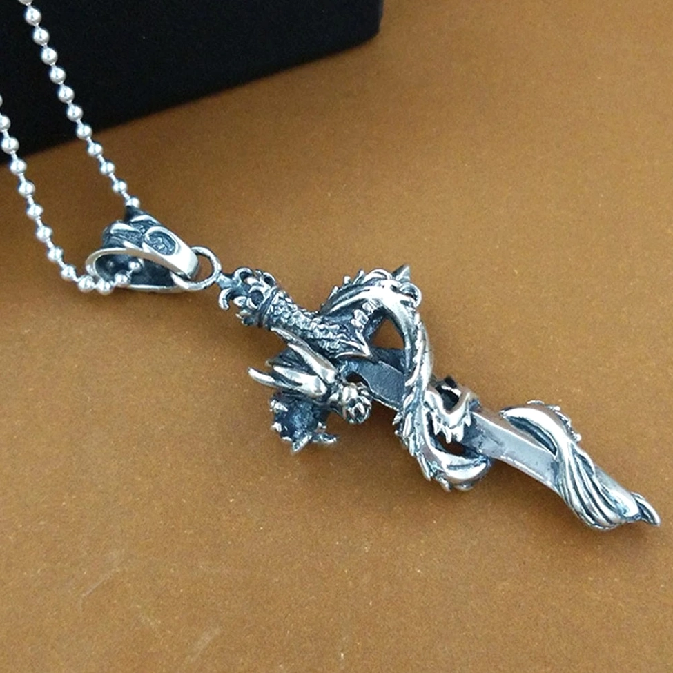 Sterling silver dragon sword pendant necklace - right side view with beaded chain and distressed vintage patina