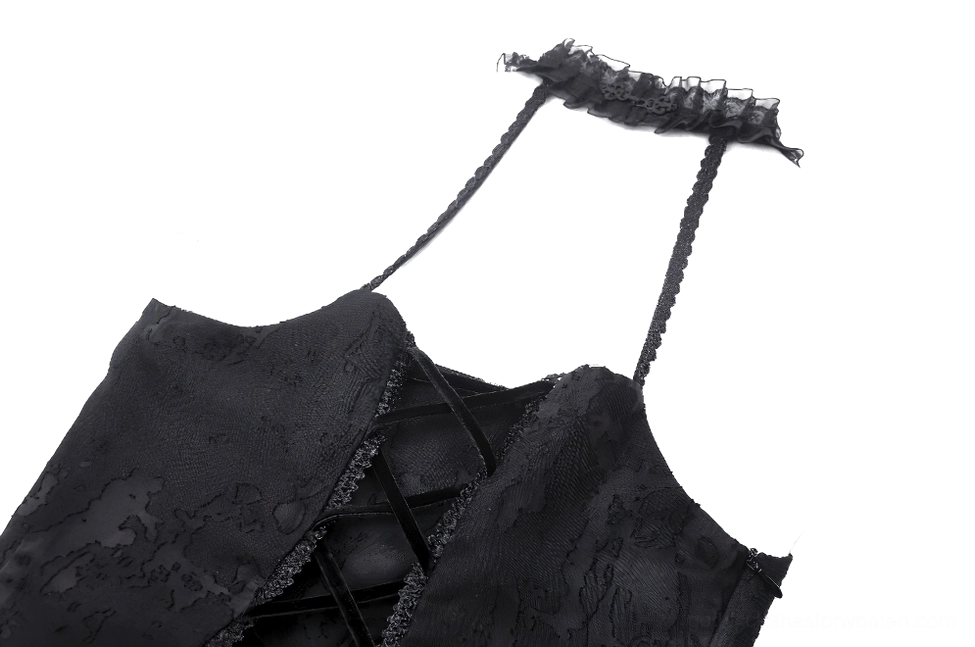 Close-up detail of gothic dress back showing lace-up corset back closure with black lace trim and authentic grommets