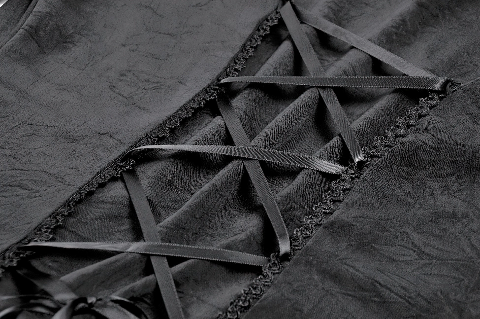 Close-up of black gothic dress back collar area showing beaded high neck trim, structured shoulder seams, and woven black fabric