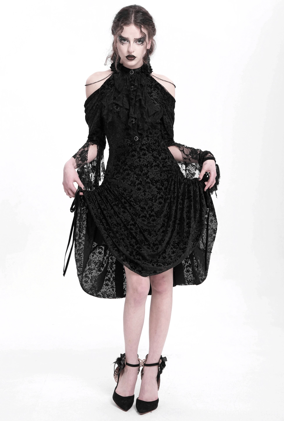 Black gothic lace dress with beaded high neckline and draped asymmetric hem, detail view