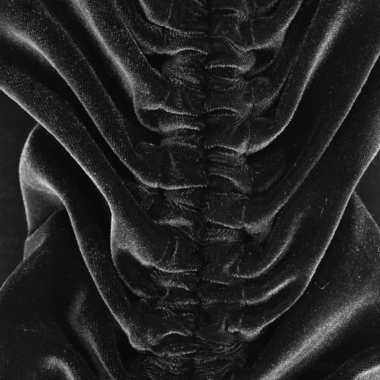Black velvet gothic dress showing adjustable bell sleeve structure and cuff gathering detail