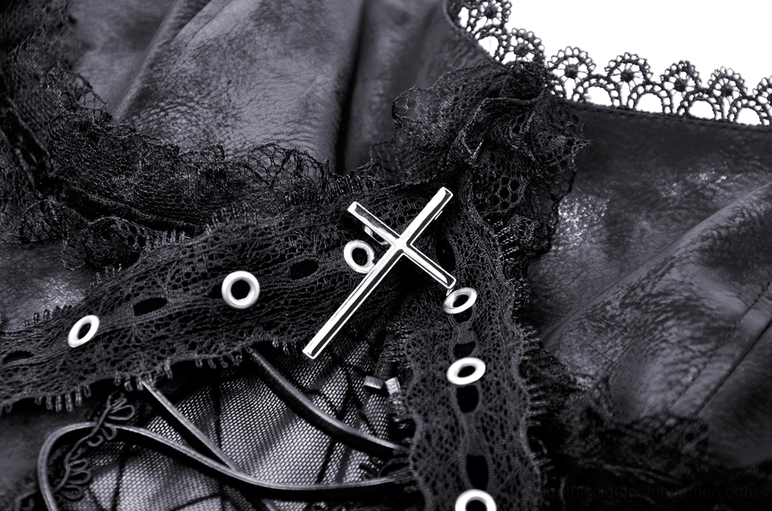 Close-up detail of black gothic dress bodice decoration featuring metal cross, lace trim, and spiderweb mesh