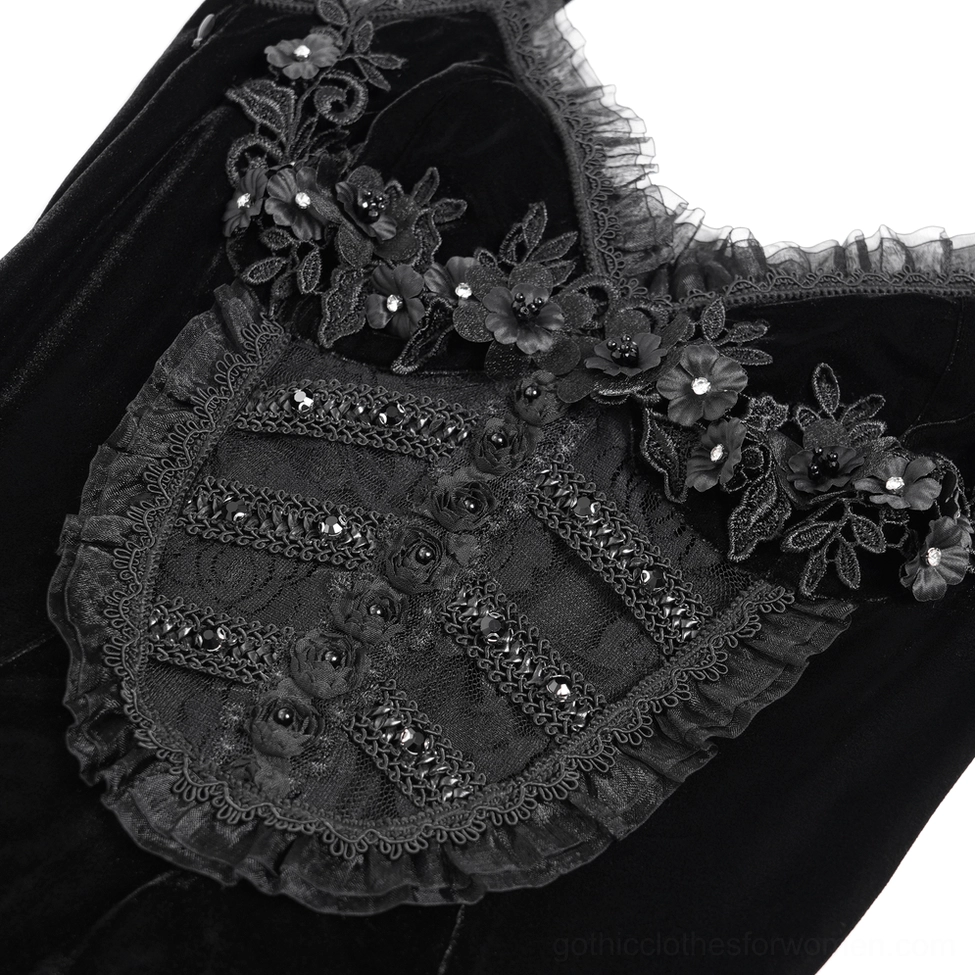 Closeup detail of black velvet gothic dress bodice with floral lace appliqué and beaded accents
