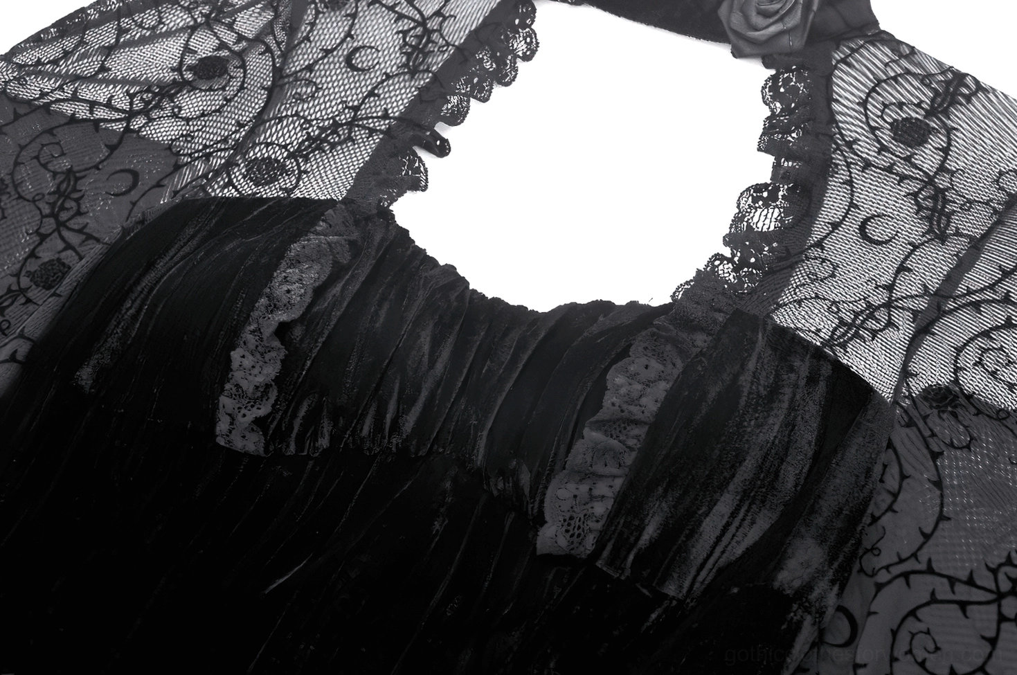 Close-up of gothic dress bodice with ruffled velvet trim and ornate lace overlay