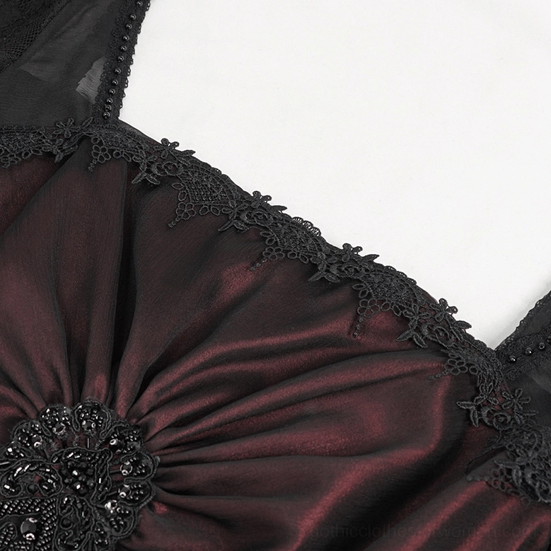 Close-up of gothic dress bodice trim, satin fabric with black lace edging and beaded floral detail