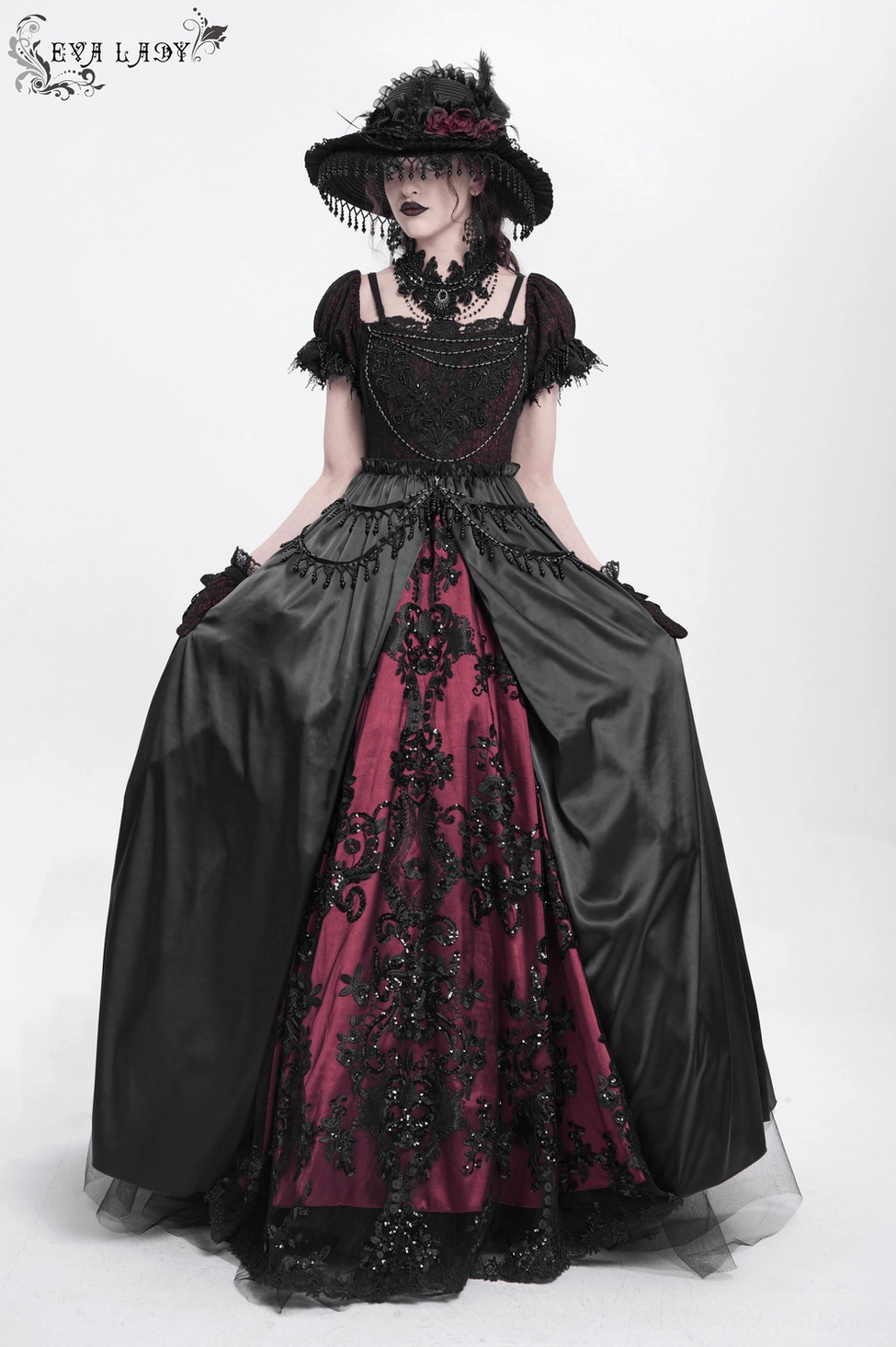 Detailed view of gothic dress showing burgundy accent skirt, beaded lace paneling, ruffle sleeve construction, and ornate embellishment work