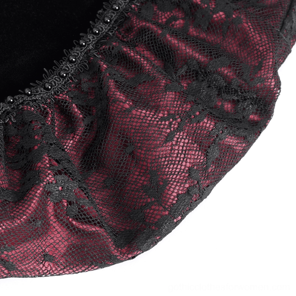 Close-up of wine red and black floral lace fabric overlay on velvet gothic dress
