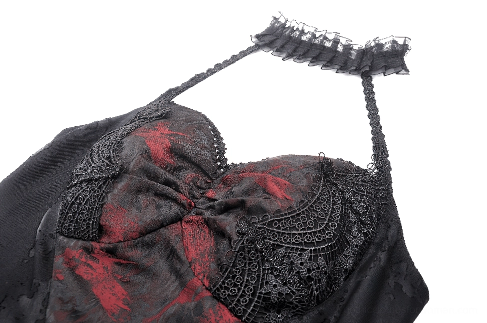 Close-up detail of black gothic dress bust featuring embossed black lace overlay and red splatter graphic print