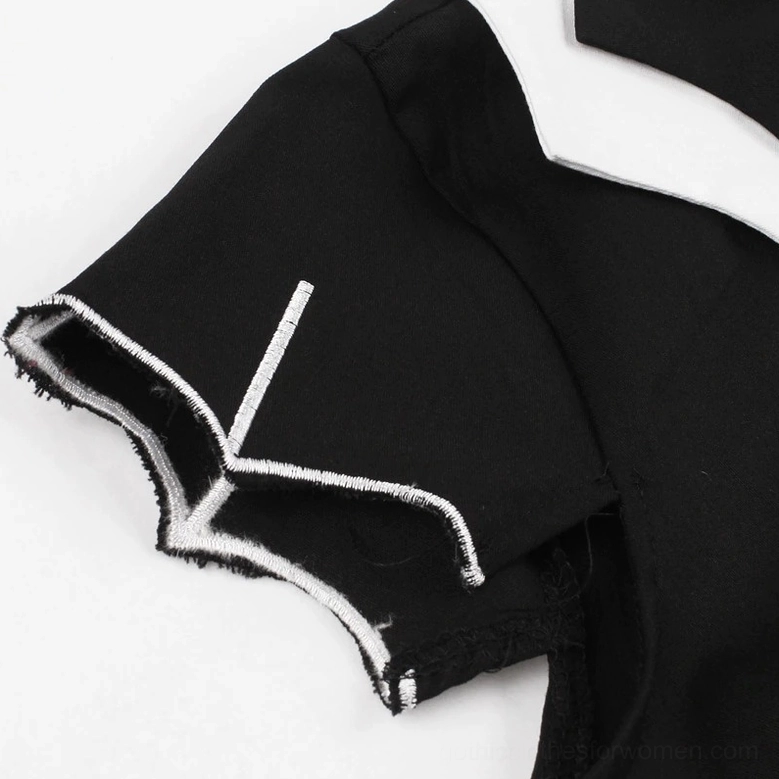 Button loop closure detail on black gothic dress neckline with white inner lining and contrast stitching