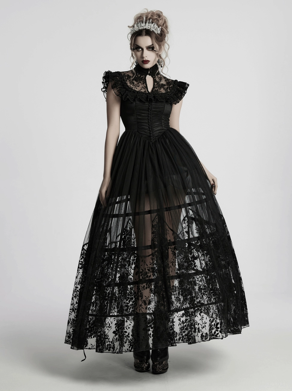 Black gothic dress construction detail - mesh panels and lace overlay demonstrating layered design