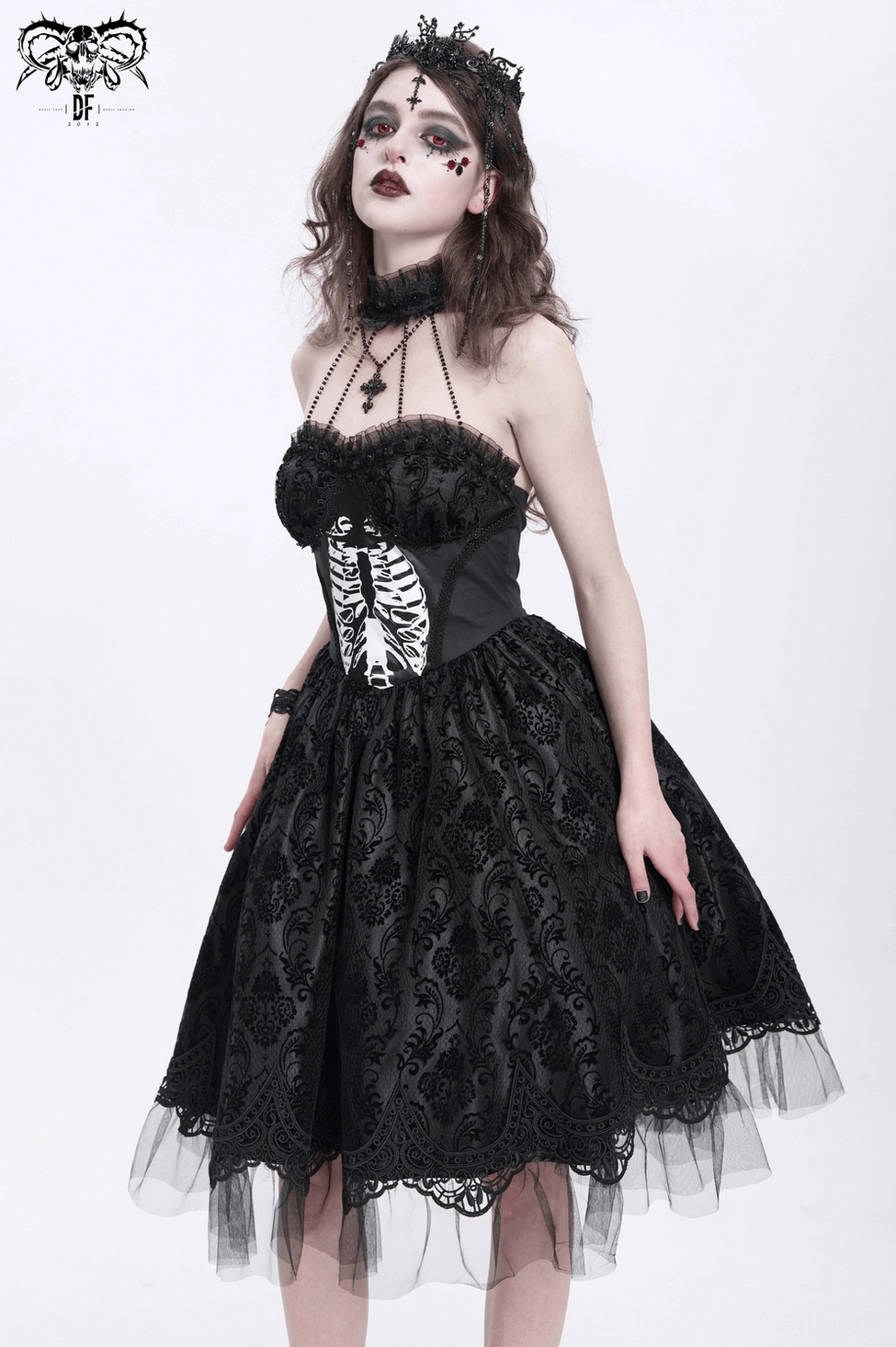 Gothic dress mannequin back view showing lace-up corset closure and intricate tulle skirt layers