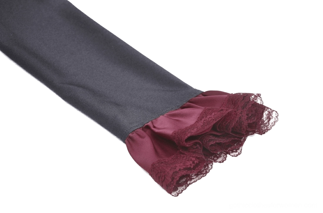 Close-up of burgundy lace trim on black sleeve cuff detail of gothic mini dress