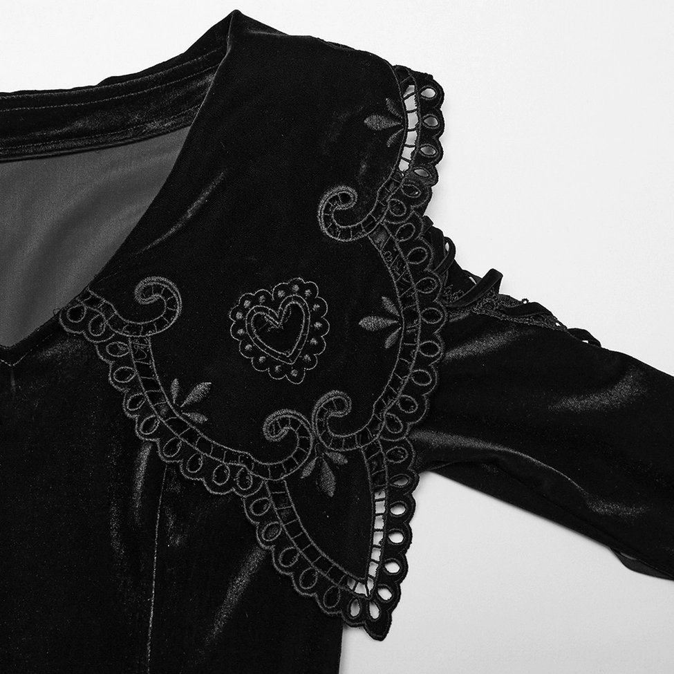 Close-up detail of black velvet gothic dress embroidered heart-shaped collar with scalloped lace trim
