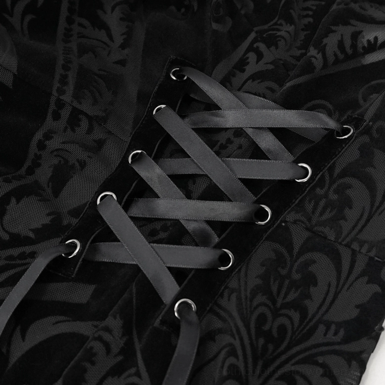 Close-up detail of black gothic dress showing semi-transparent fabric, damask print pattern, and sleeve construction