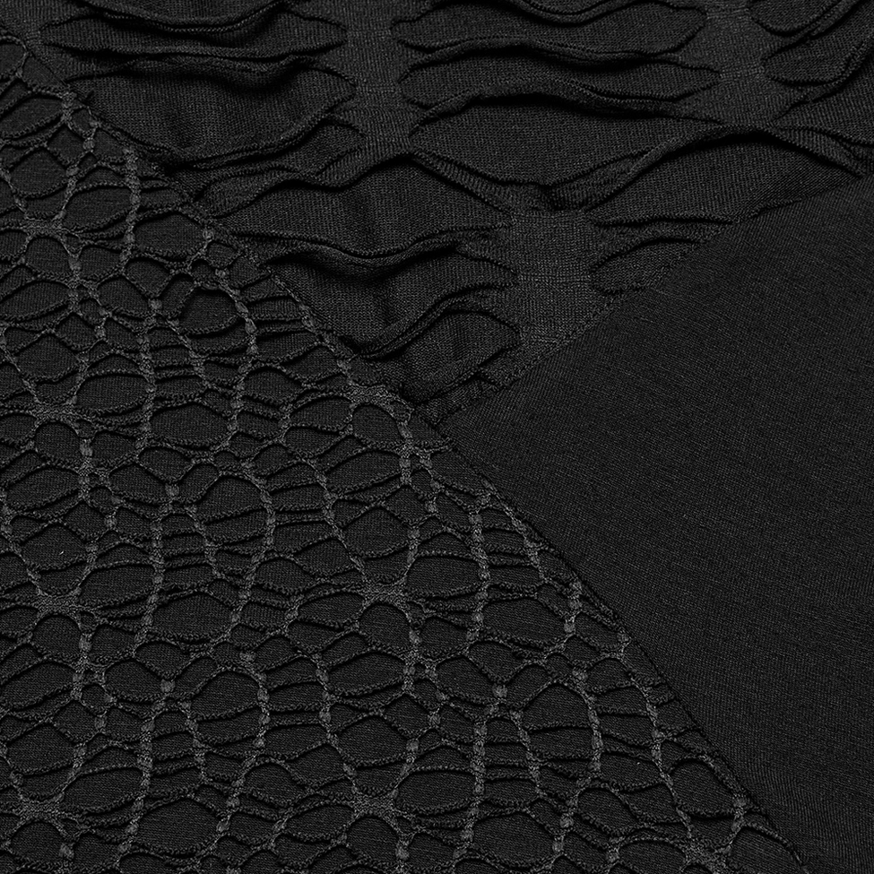 Close-up texture of black gothic dress showing mixed smooth knit and perforated mesh fabric panels