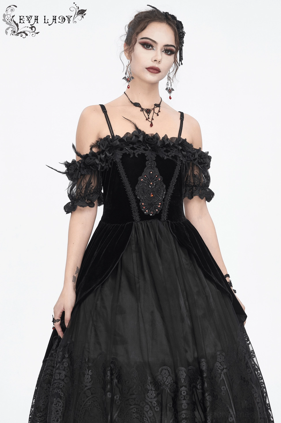Black gothic dress close-up showing feather sleeve and lace combination - detailed craftsmanship view
