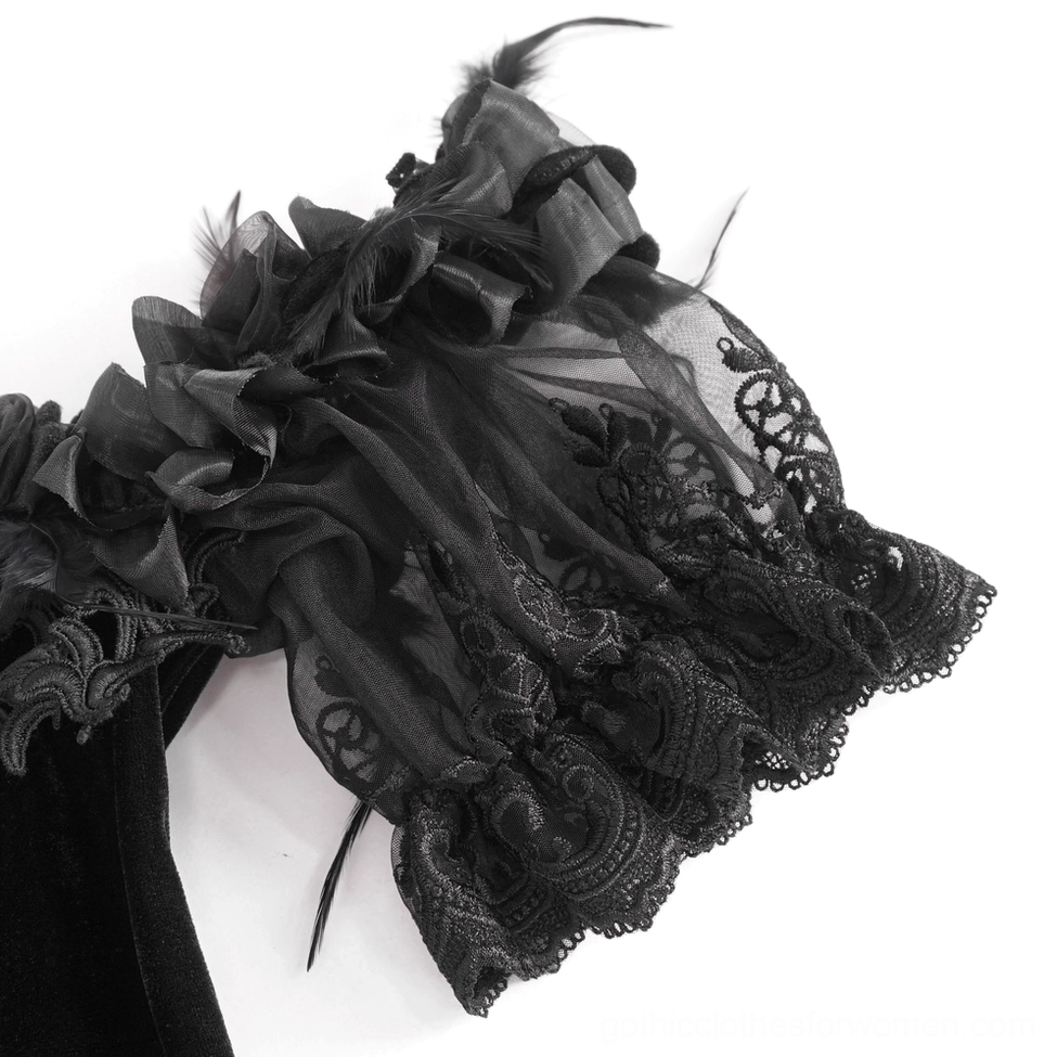 Close-up of black gothic dress sleeve trim featuring feather decoration and lace ruffle with sheer mesh fabric detail