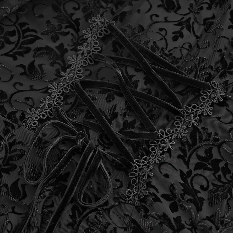 Detailed view of floral velvet burnout fabric pattern and decorative lace trim on gothic dress