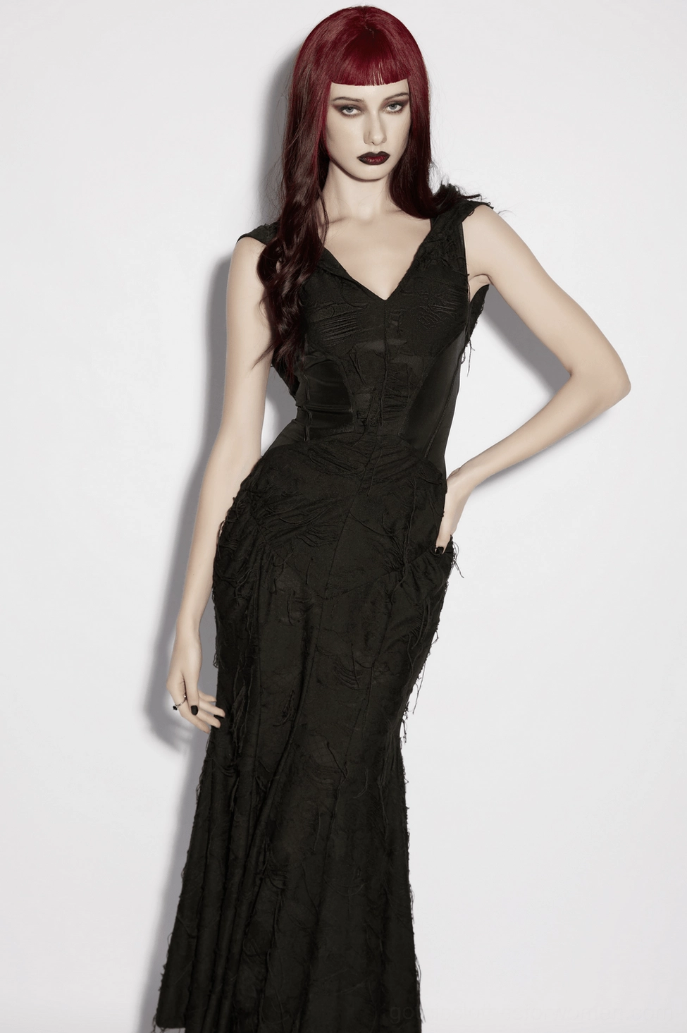 Black gothic maxi dress distressed frayed hem fabric texture close-up showing matte finish and worn-in edge