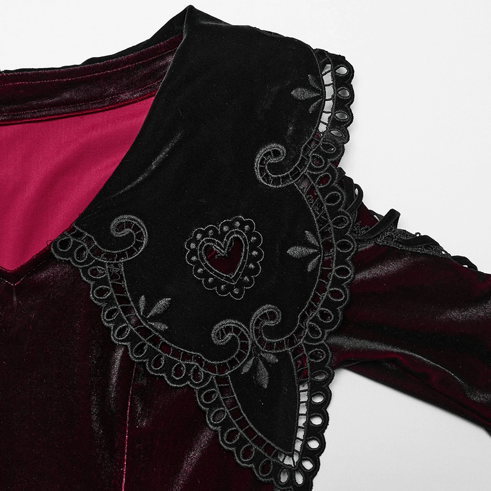 Close-up detail of burgundy gothic dress heart-shaped lace collar with black embroidered lace and velvet fabric texture