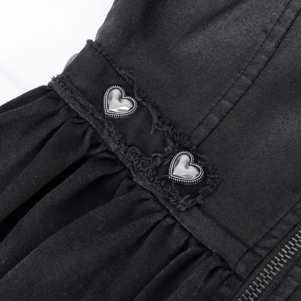 Close-up of heart-shaped metal buttons and frayed fabric edge details on gothic asymmetric dress