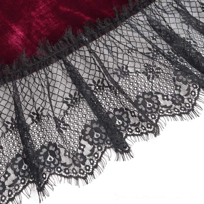 Macro detail shot of black mesh floral lace and frayed scalloped trim on wine red dress hem