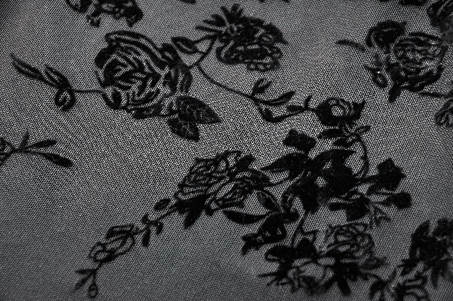 Black lace dress hem detail showing scalloped edge and floral lace pattern