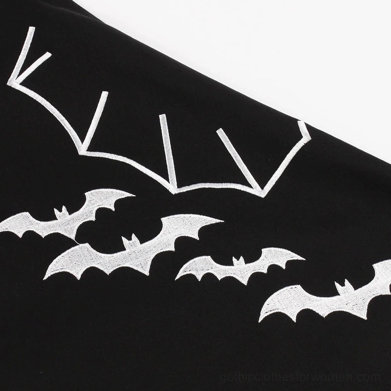 Neatly stitched black fabric hem on gothic A-line dress showing quality construction and professional finishing