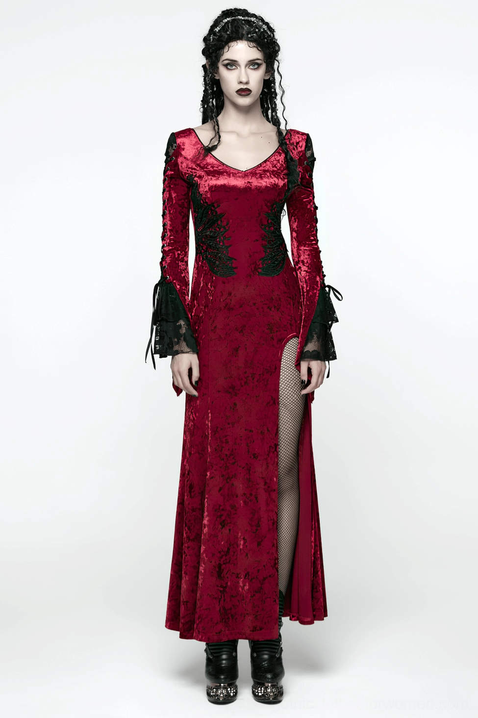 High side slit detail of crimson velvet gothic dress showing black lace panels and daring hem opening