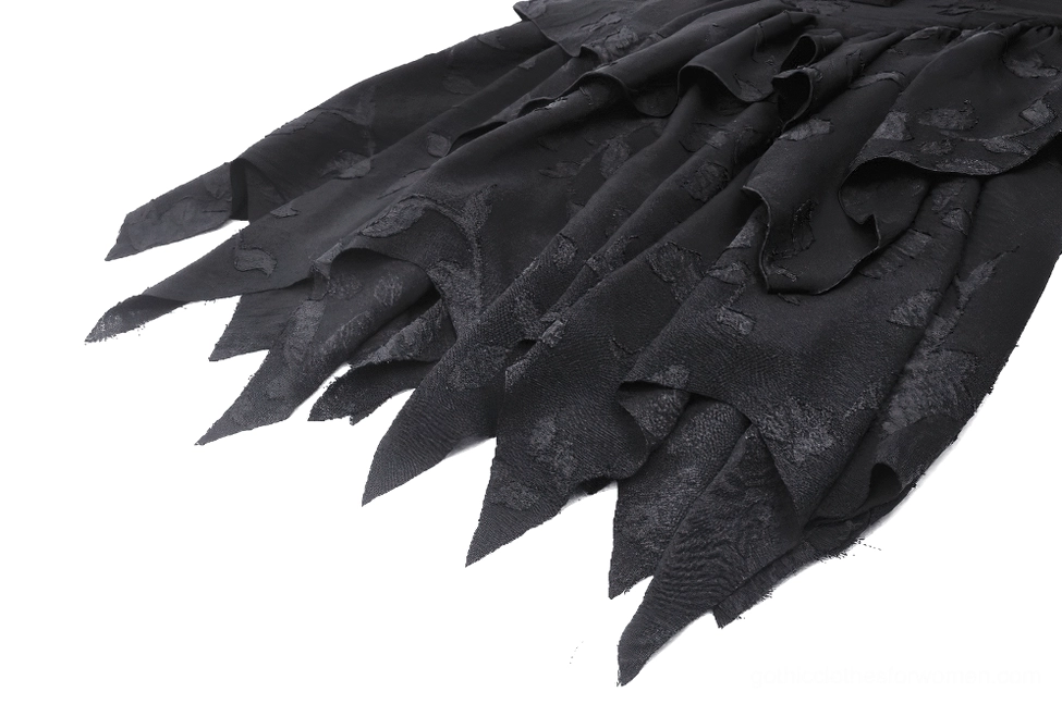 Flat lay close-up detail of gothic dress multi-layered jagged ruffled hemline showing irregular edges