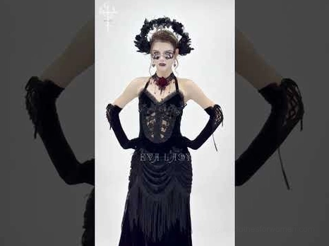 Black velvet gothic halter dress detail shot showing lace bodice and fringe skirt with model styling