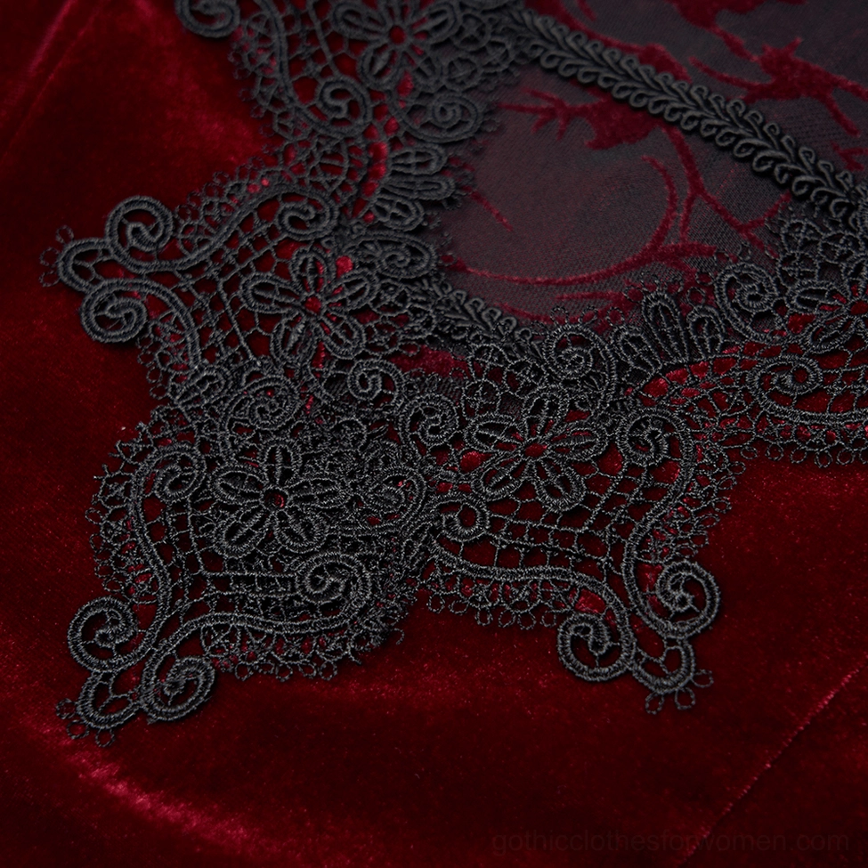 Close-up of intricate black floral lace decoration on burgundy velvet gothic dress neckline and yoke