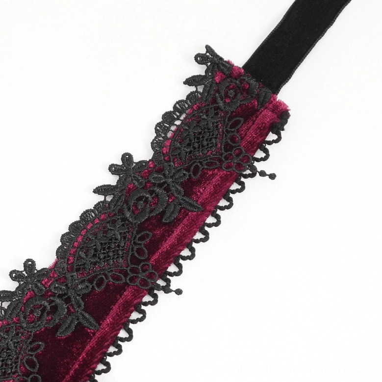 Close-up detail of black floral lace trim and scalloped edge on gothic dress shoulder strap