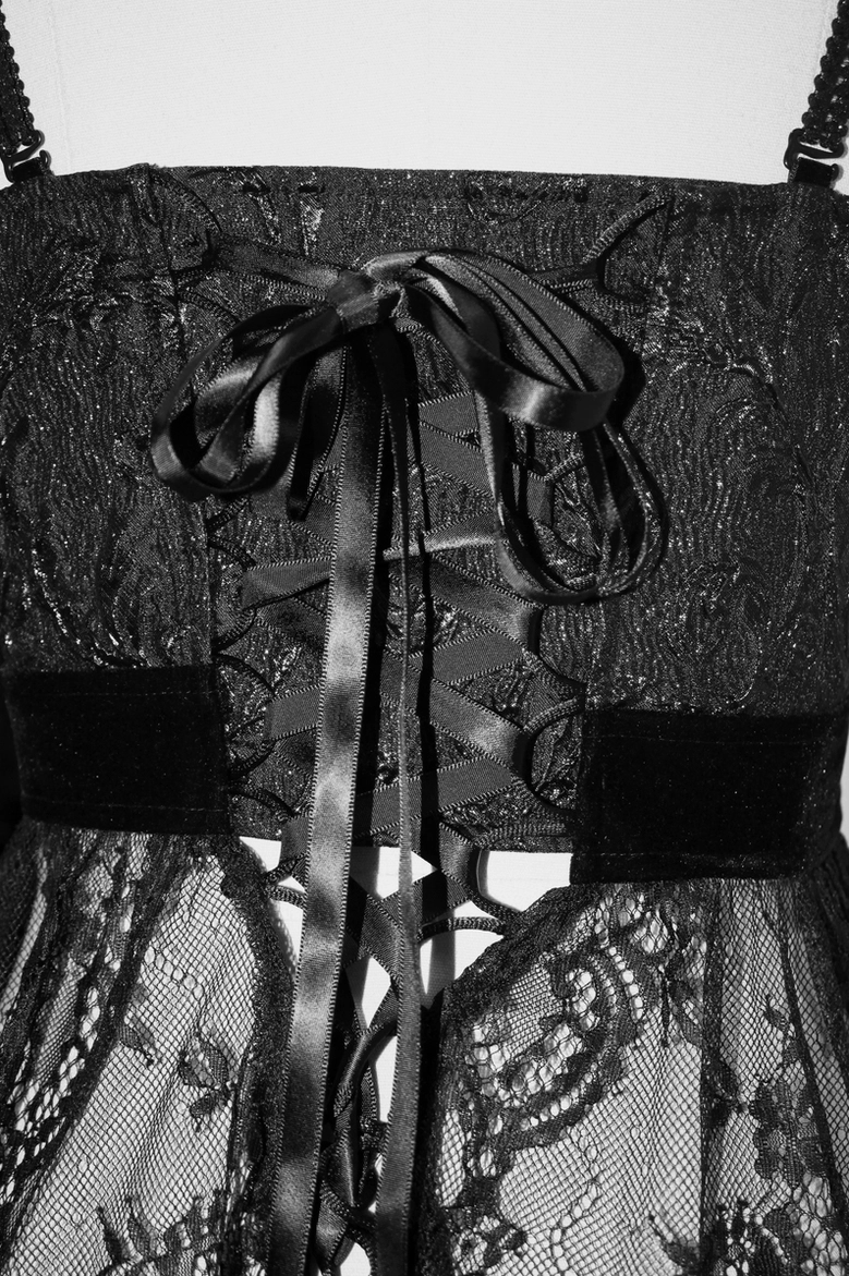 Close-up of gothic dress back lace-up closure with satin ribbon bow, velvet waistband, and black lace structure
