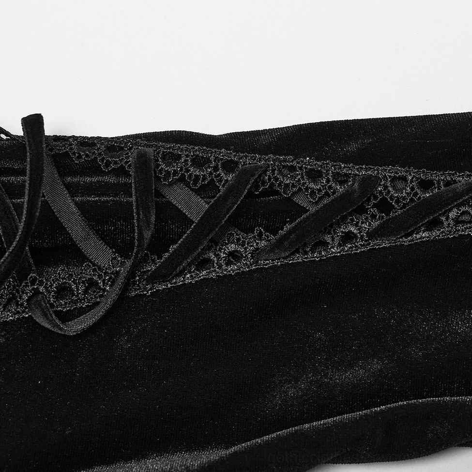 Close-up of black velvet gothic dress sleeve lace-up detail, showing velvet ribbon lacing and embroidered lace trim
