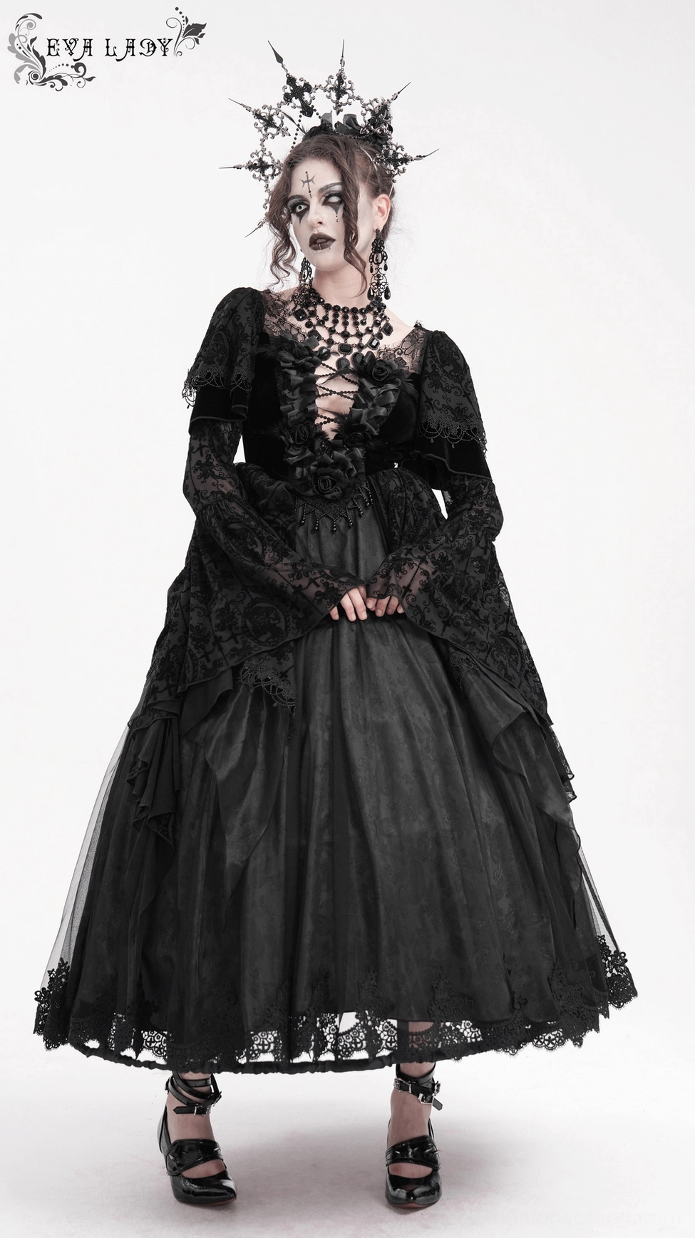 Black gothic dress front angle showing lace-up bodice, bell sleeves, and detailed lace fabric with satin rose embellishments