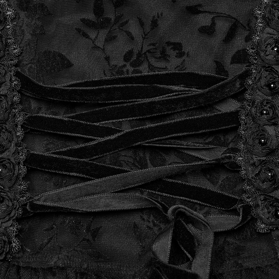 Close-up of black gothic dress lacing - velvet lace-up straps with floral lace fabric detail
