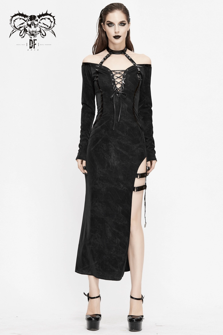 Gothic dress detail view showing leather strap embellishments and metal ring hardware on black velvet base